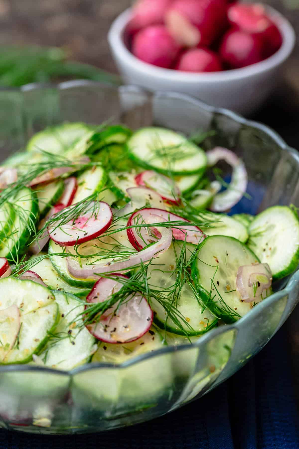 cucumber salad in a bowl. A side bowl of radish