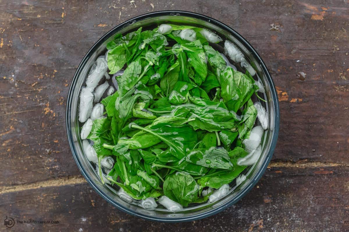 basil leaves in an bowl of iced water