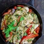 pesto chicken and vegetables in a pan