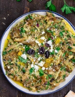 melitzanosalata (Greek eggplant dip) garnished with parsley, feta and olives