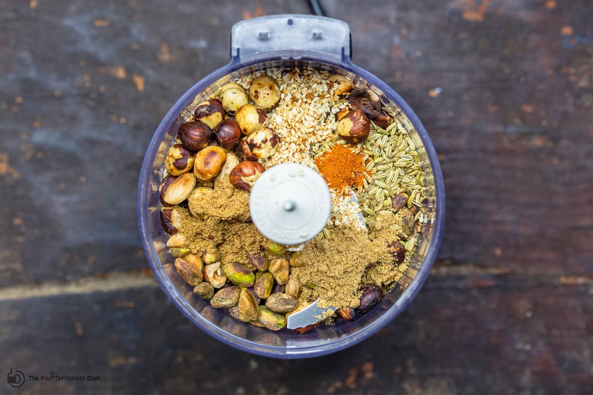 nuts, seeds, and spices in a food processor before grinding