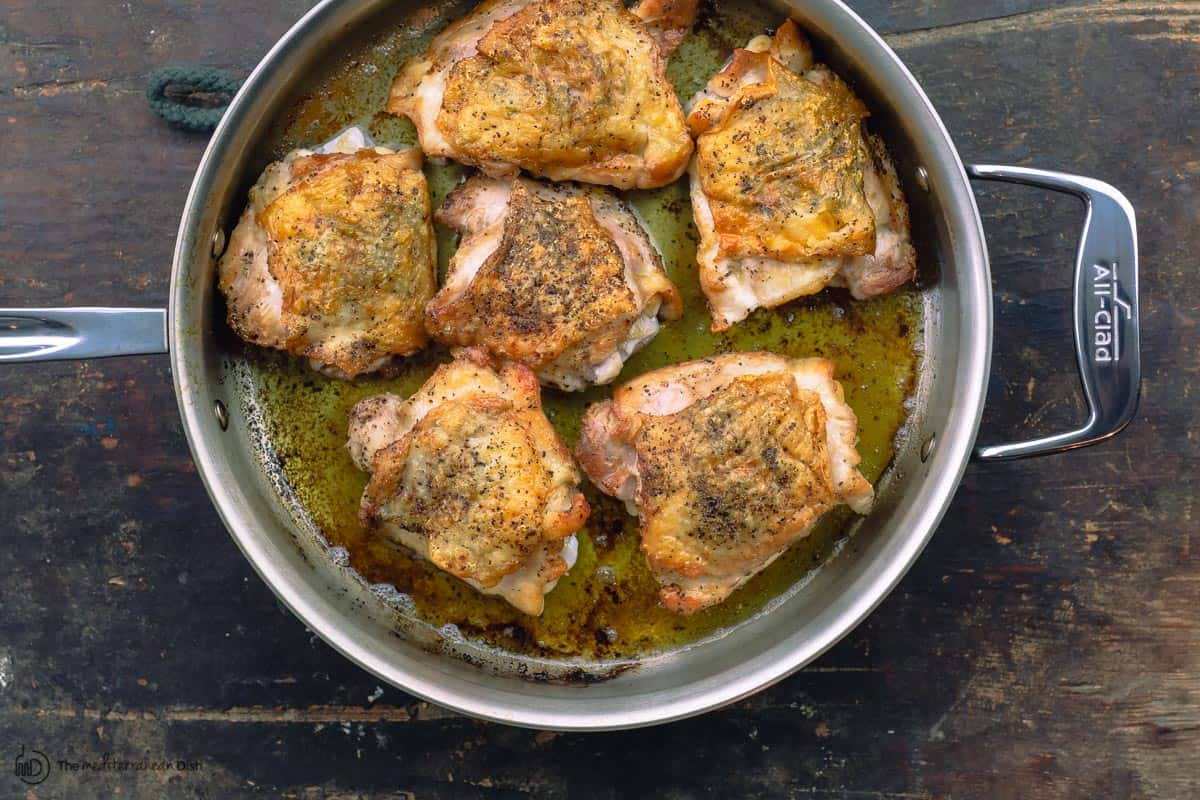 chicken pieces browned in a braiser pan