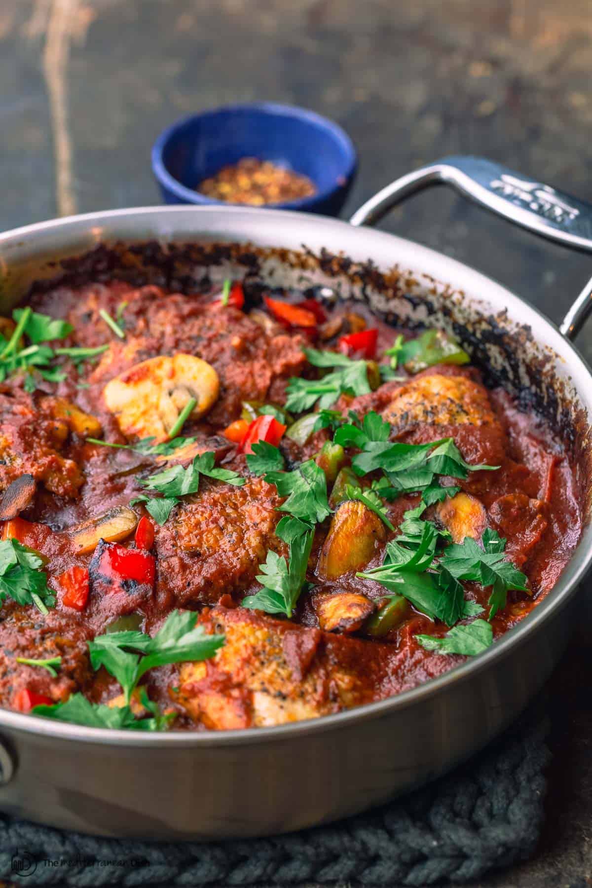 one pan chicken cacciatore with a small bowl of red peppers