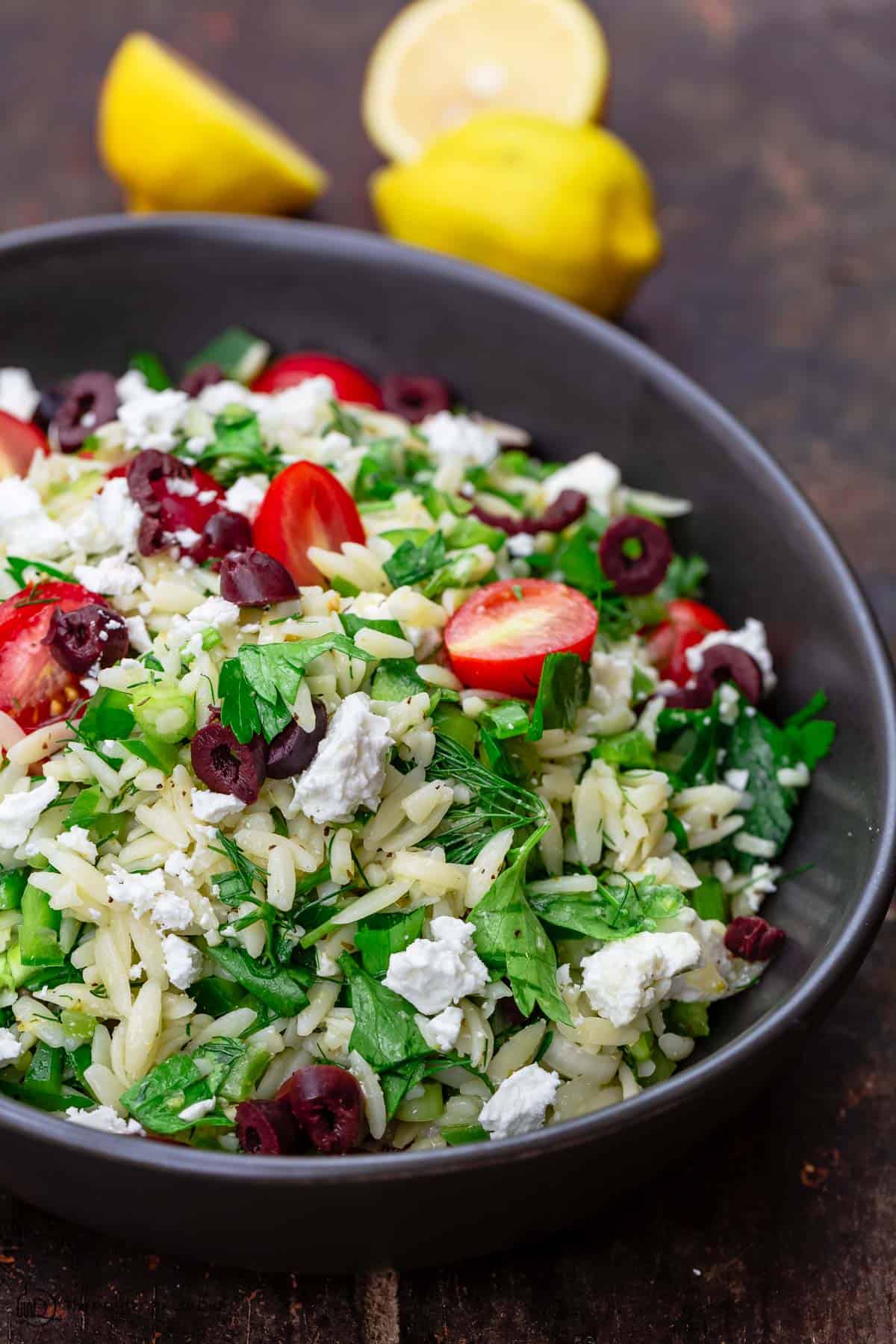 Greek orzo salad with a side of lemons