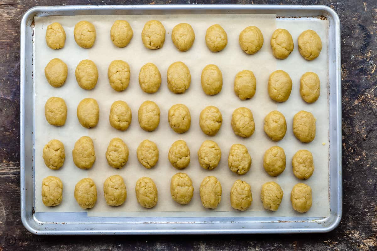 Dough shaped into oval cookies on sheet pan