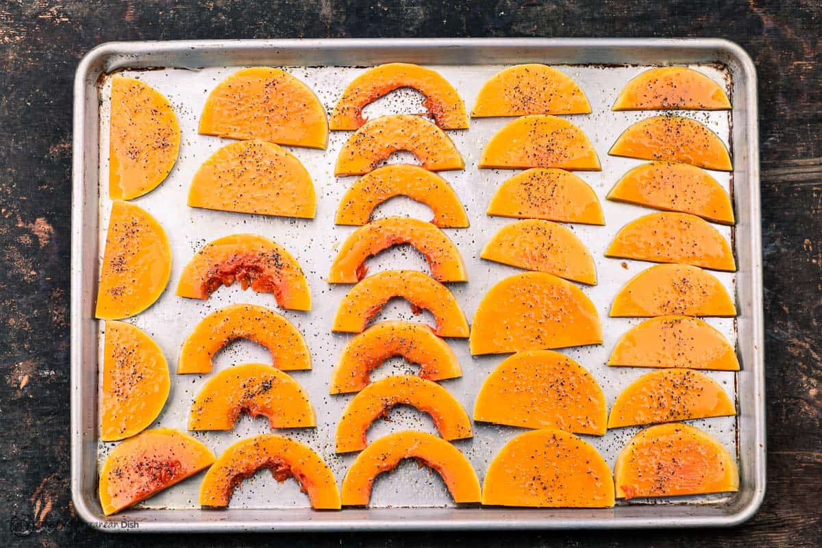 Slices of butternut squash on a baking sheet