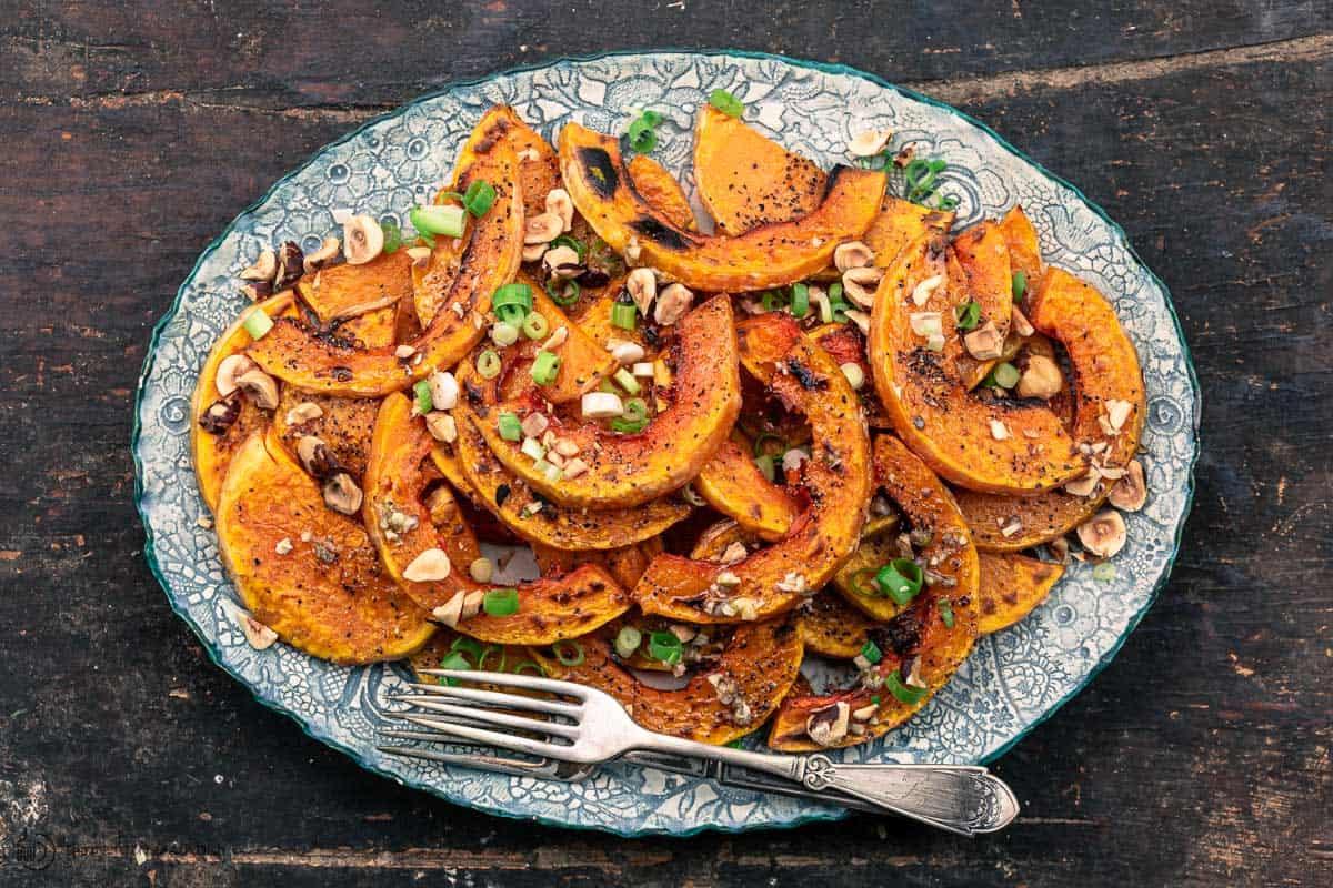 roasted butternut squash topped with lime vinaigrette, hazelnut, and scallions