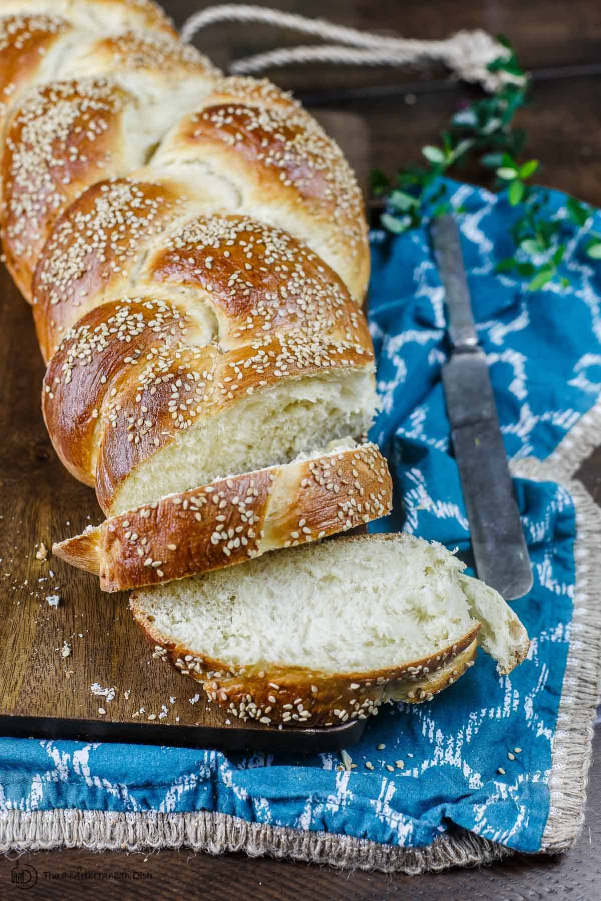 Challah bread sliced onto a board