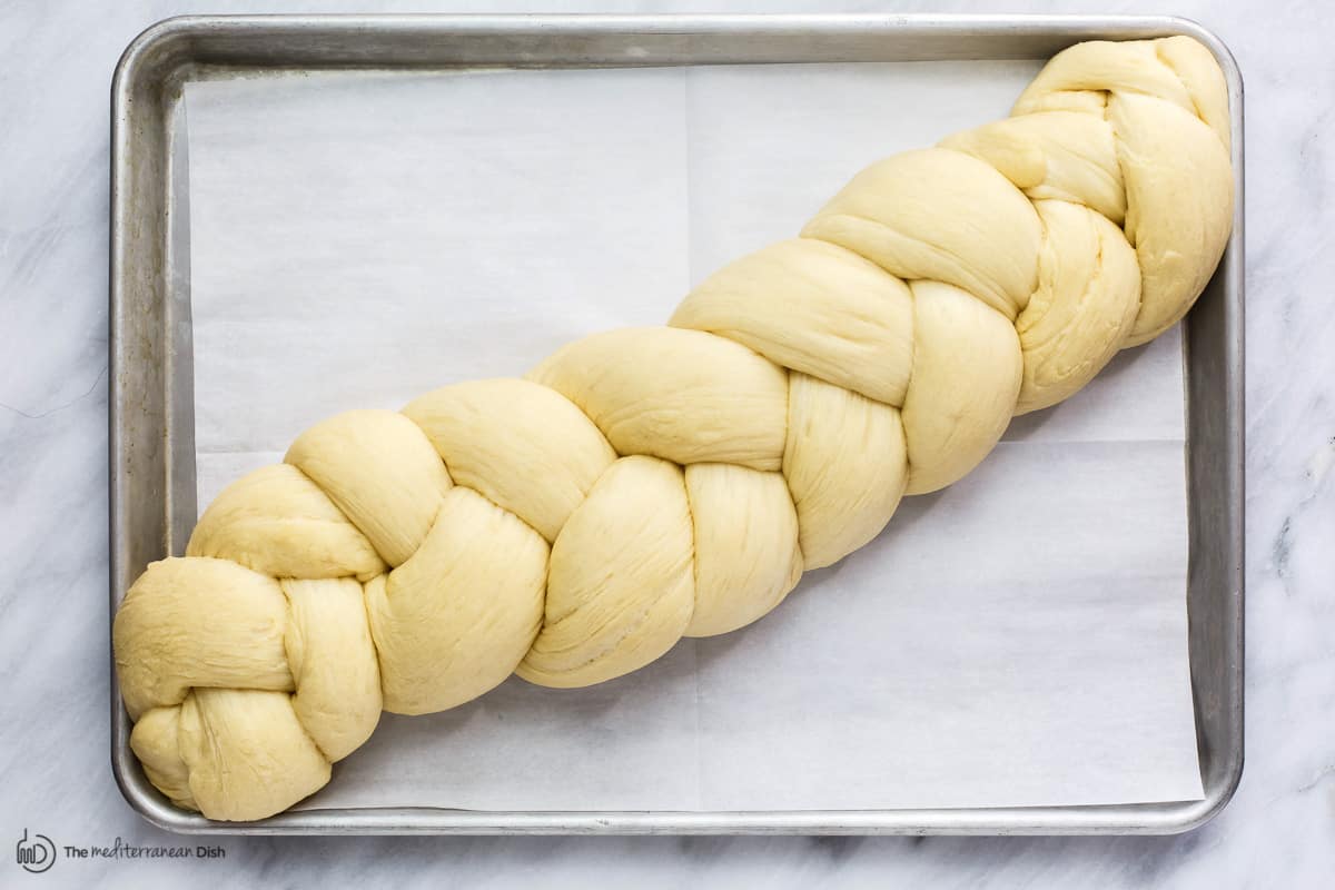 Raised braided dough on baking sheet