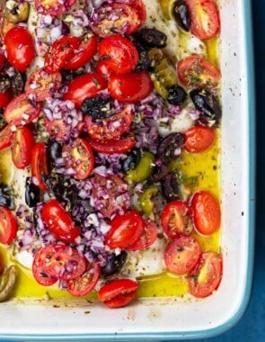 White fish topped with tomatoes and olives