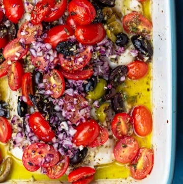 White fish topped with tomatoes and olives