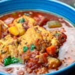 Mediterranean-style chicken stew served in a blue bowl