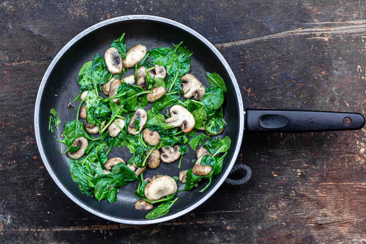 mushrooms and spinach in a nonstick pan.