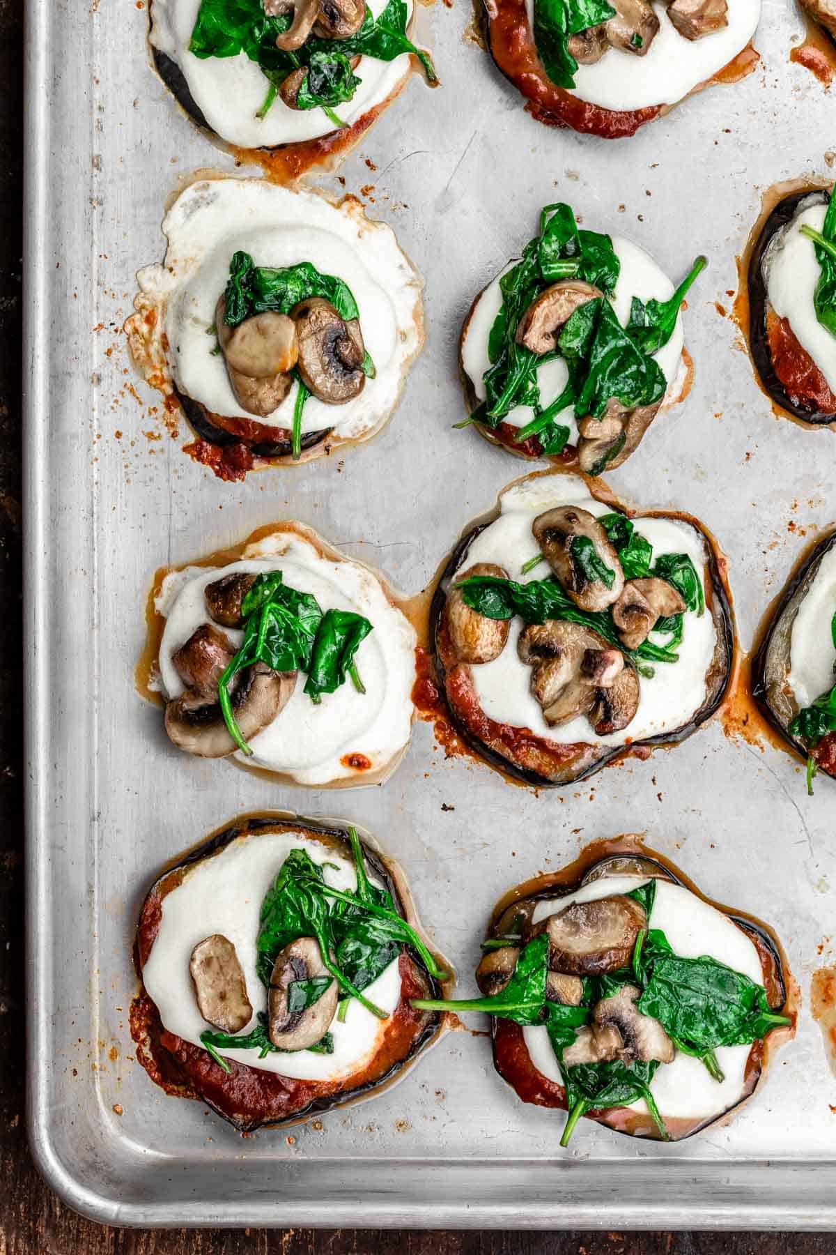 Roasted eggplant pizza with mozzarella, mushrooms and spinach.