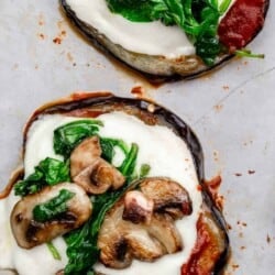 eggplant pizza bites topped with mushrooms and spinach.