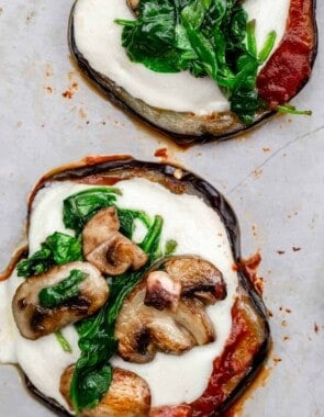 eggplant pizza bites topped with mushrooms and spinach.