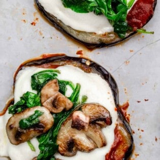 eggplant pizza bites topped with mushrooms and spinach.