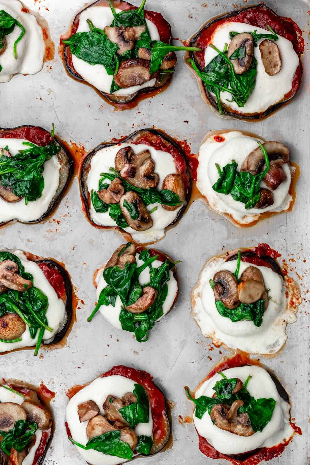 eggplant pizza with marinara sauce, mozzarella cheese, mushrooms, and spinach.