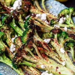 roasted broccoli with lemon wedges on the side