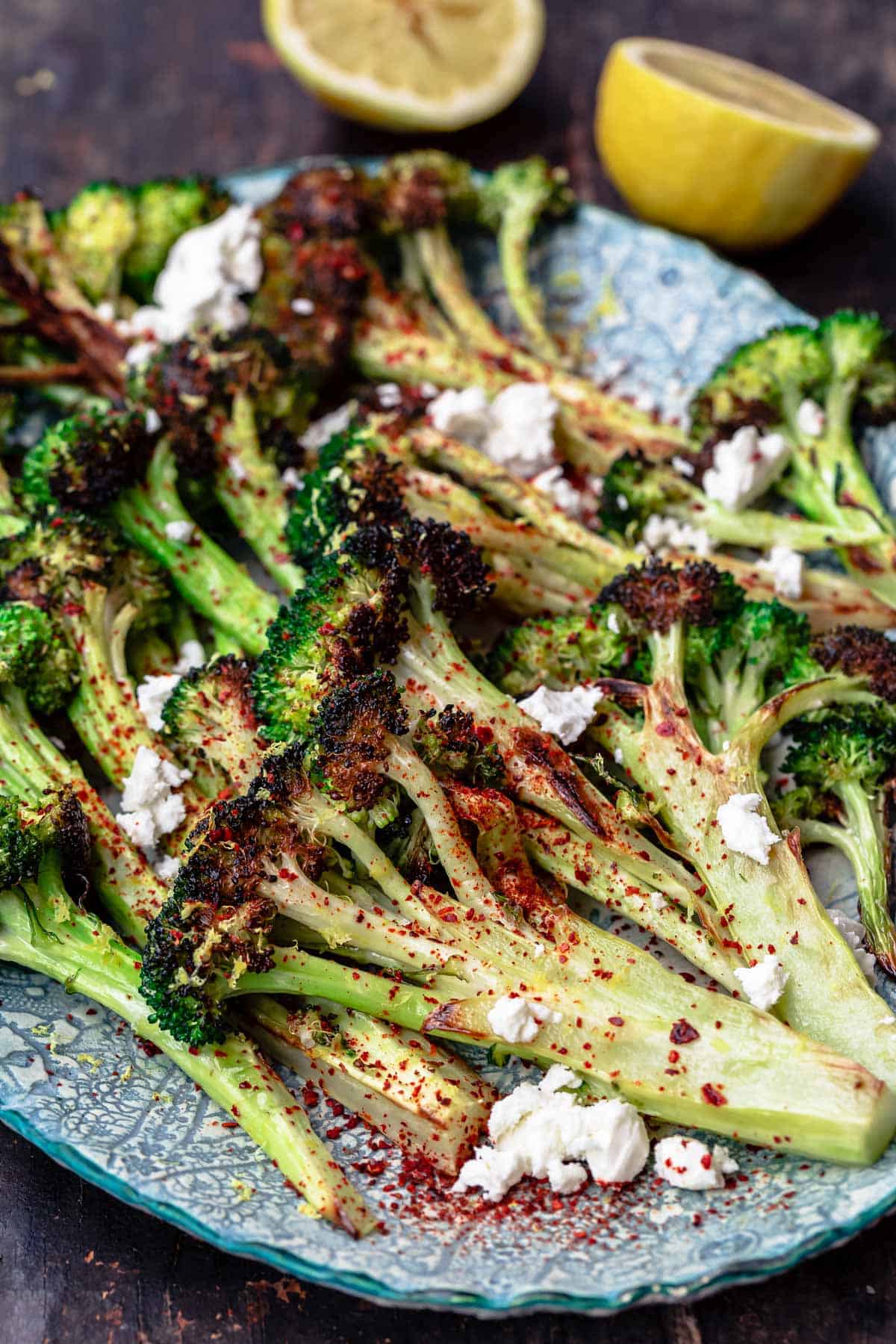roasted broccoli with lemon wedges on the side