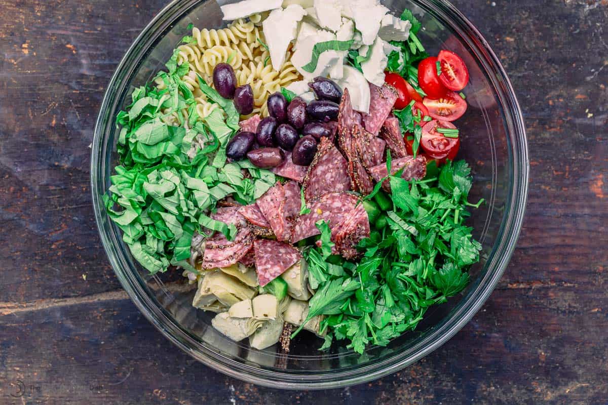 big bowl with ingredients for pasta salad