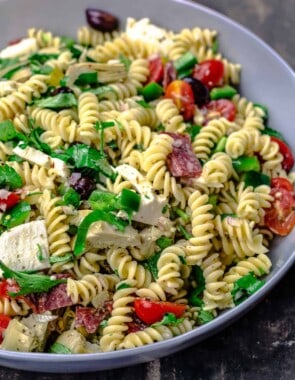 Italian pasta salad with fresh veggies, mozzarella and salami, tossed in a big bowl