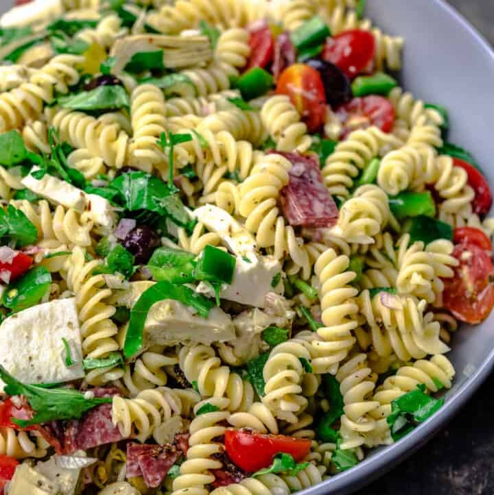 Italian pasta salad with fresh veggies, mozzarella and salami, tossed in a big bowl