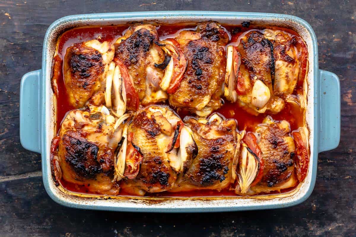 Baked chicken thighs in a blue baking dish