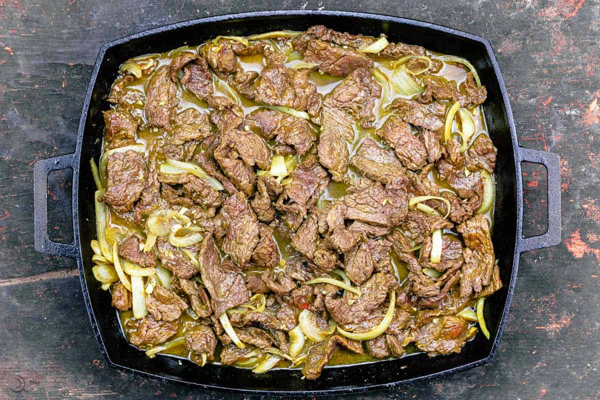 sliced beef grilled in cast iron skillet