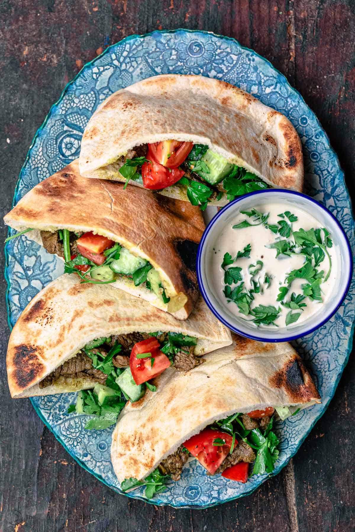 Top down picture of beef shawarma pitas served on a plate