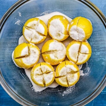 Cut lemons stuffed with a mixture of kosher salt in a bowl