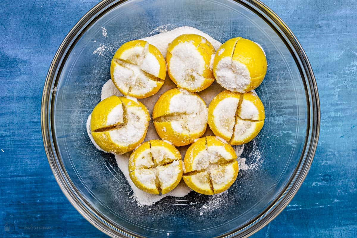 Cut lemons stuffed with a mixture of kosher salt in a bowl