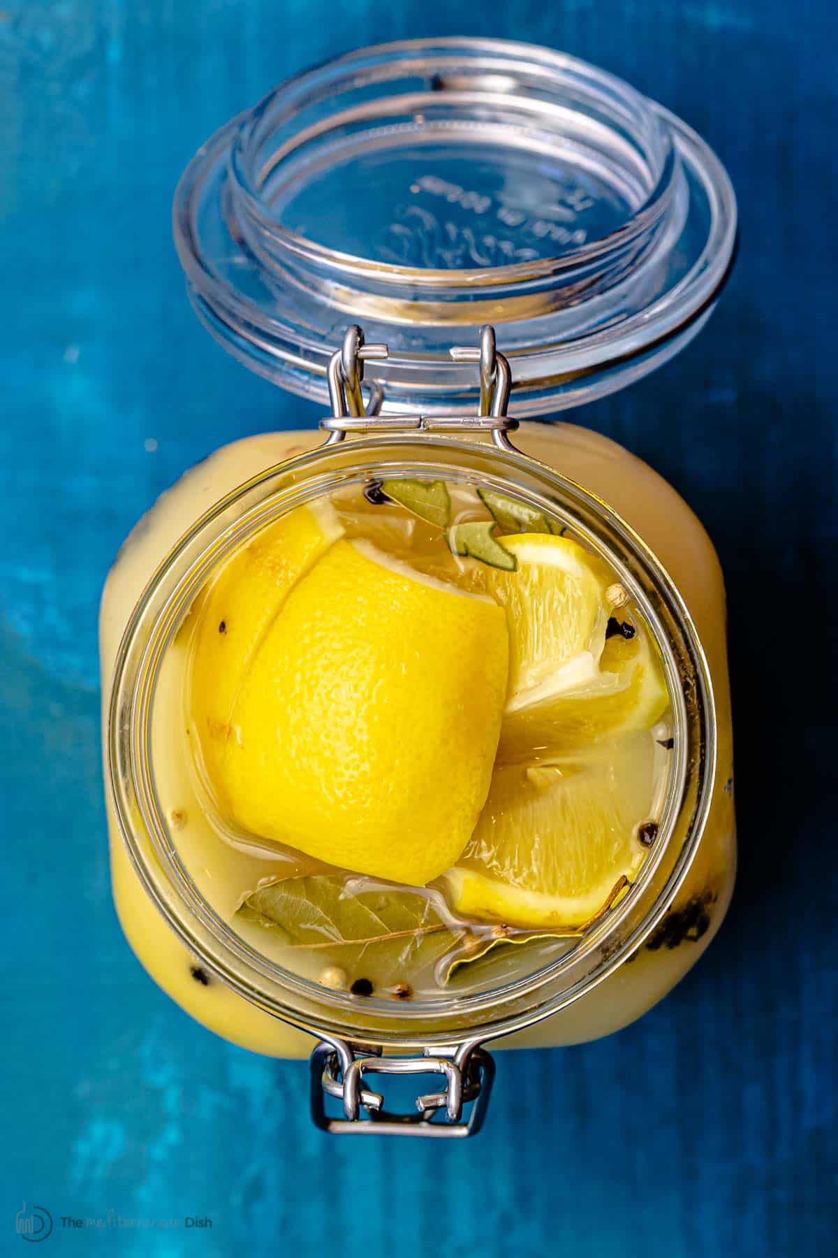 Top down picture of preserved lemons in a jar