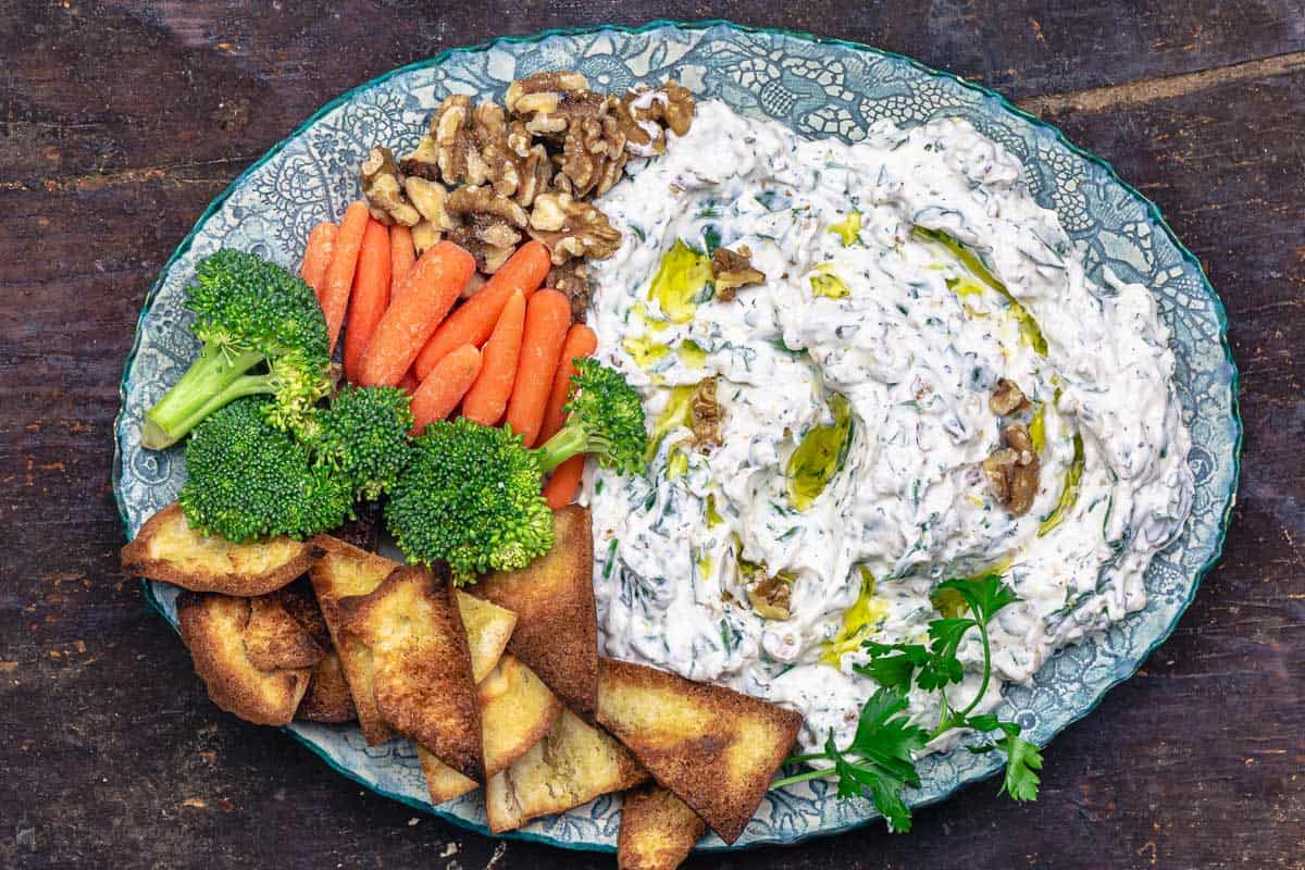 Greek yogurt veggie dip served with fresh veggies and homemade pita chips