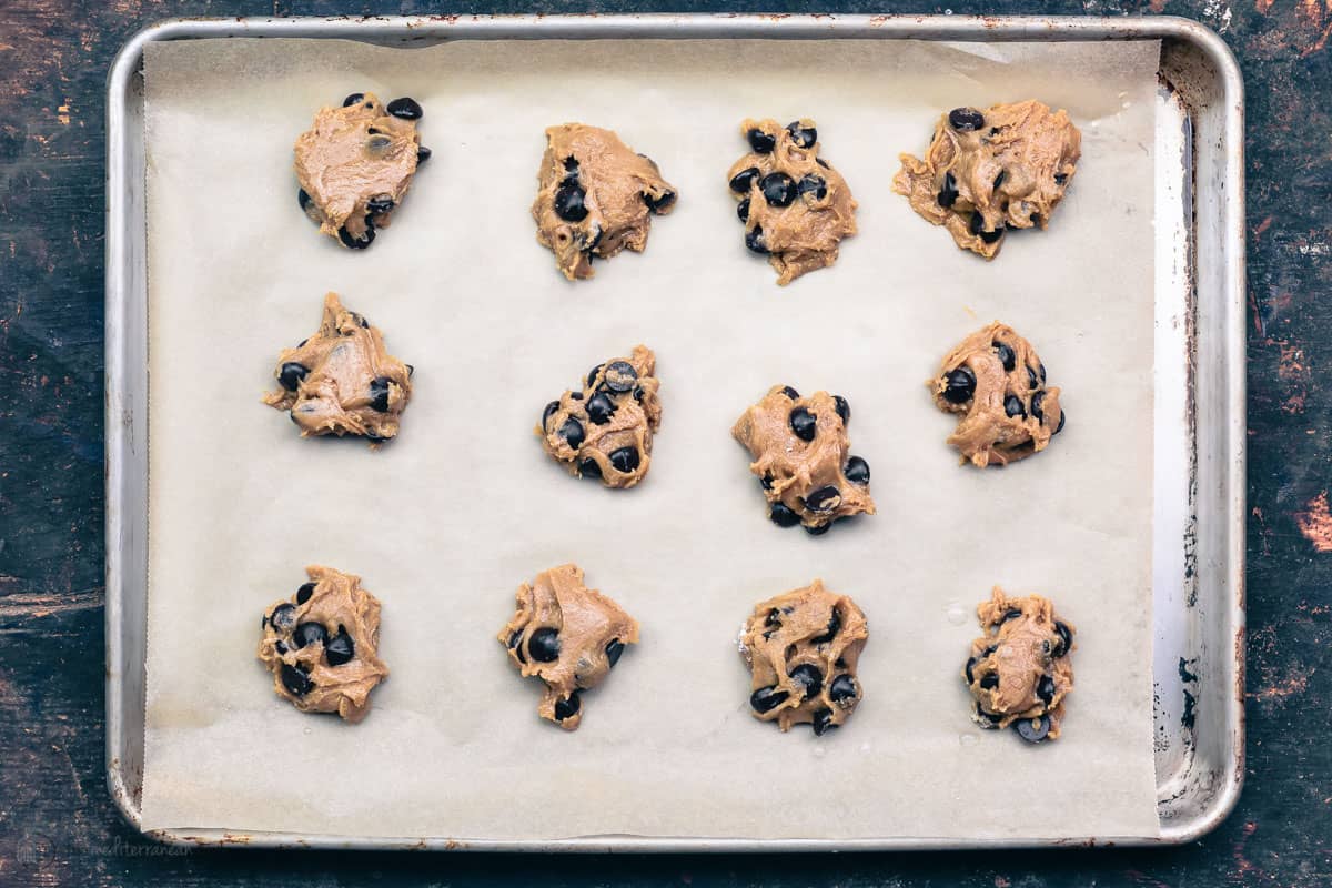 dough formed into rounds on a cookie sheet that's been lined with parchment paper