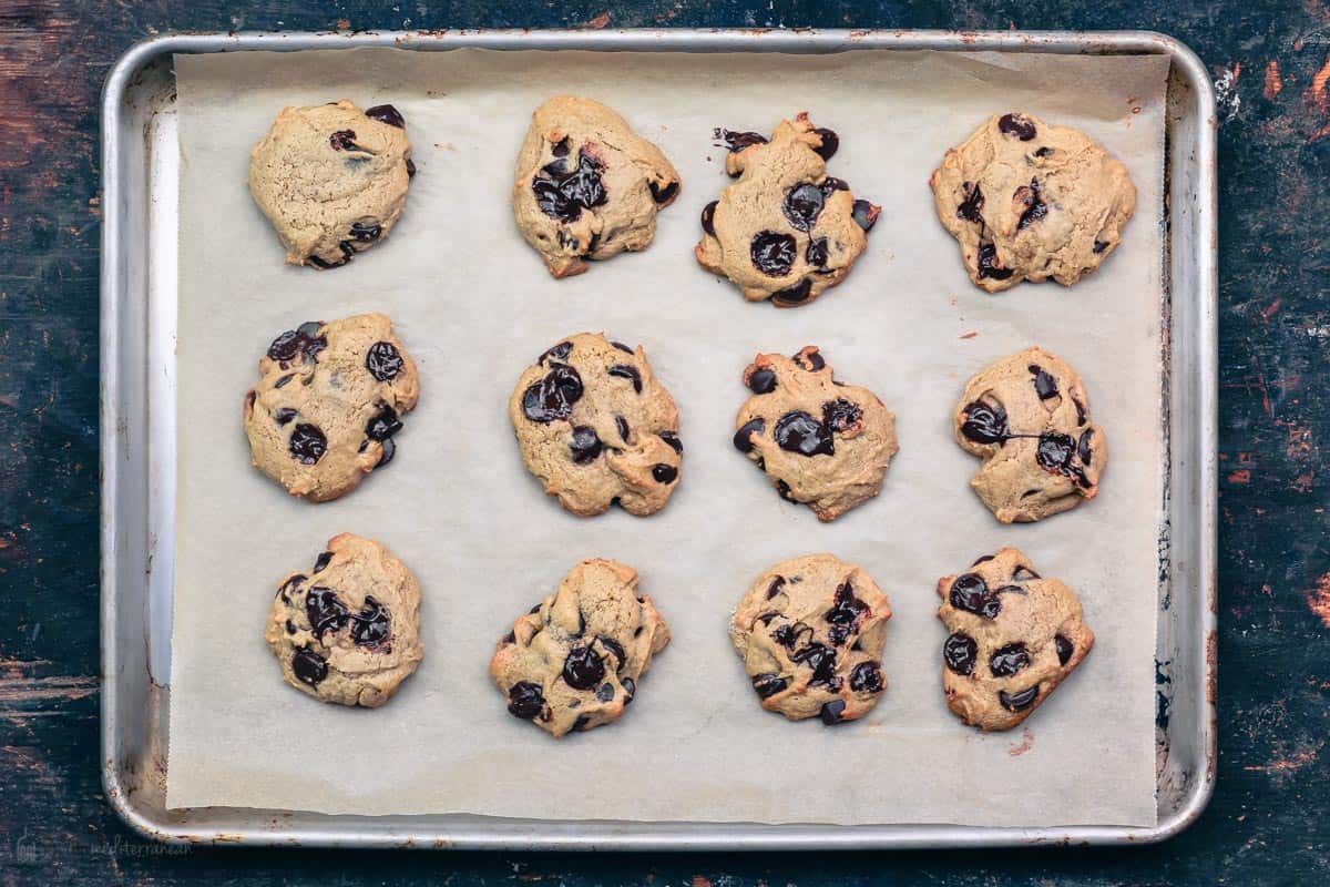fully baked tahini chocolate chip cookies on the sheet pan