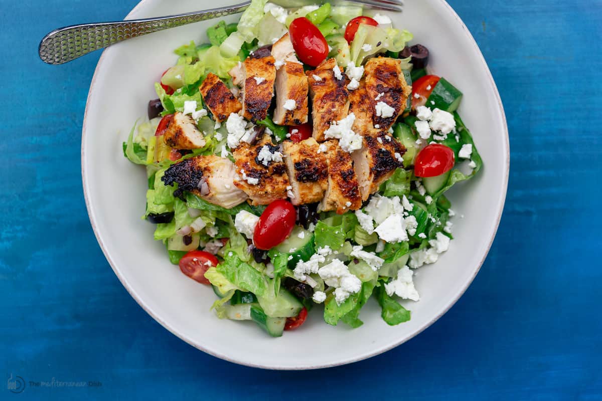 Greek chicken salad served in a white bowl