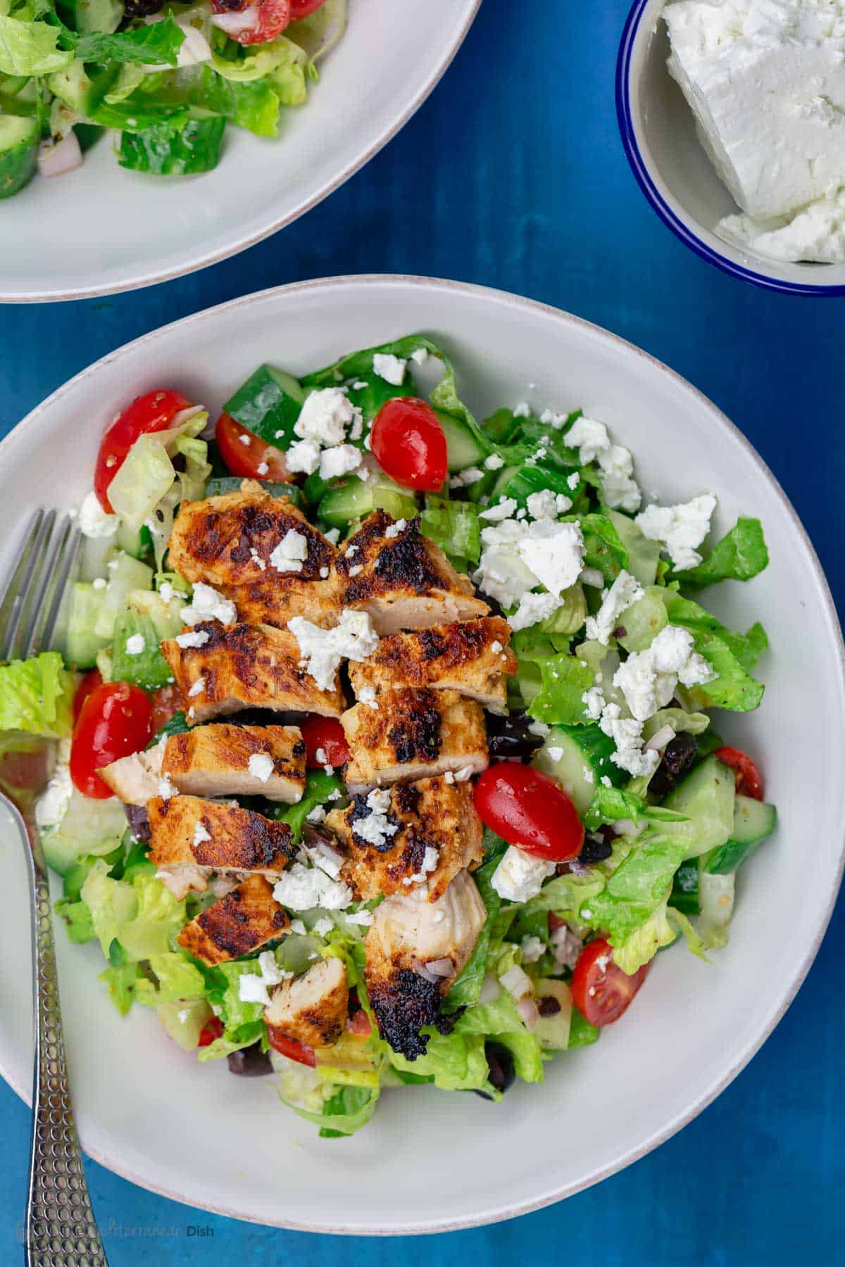 Top down picture of Greek chicken salad served in a white bowl