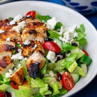 Greek chicken salad served in a white bowl