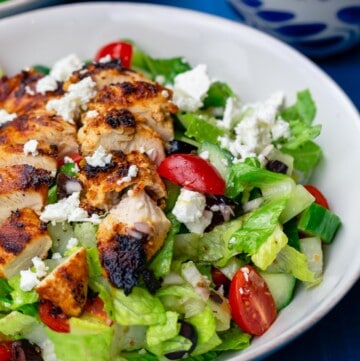 Greek chicken salad served in a white bowl
