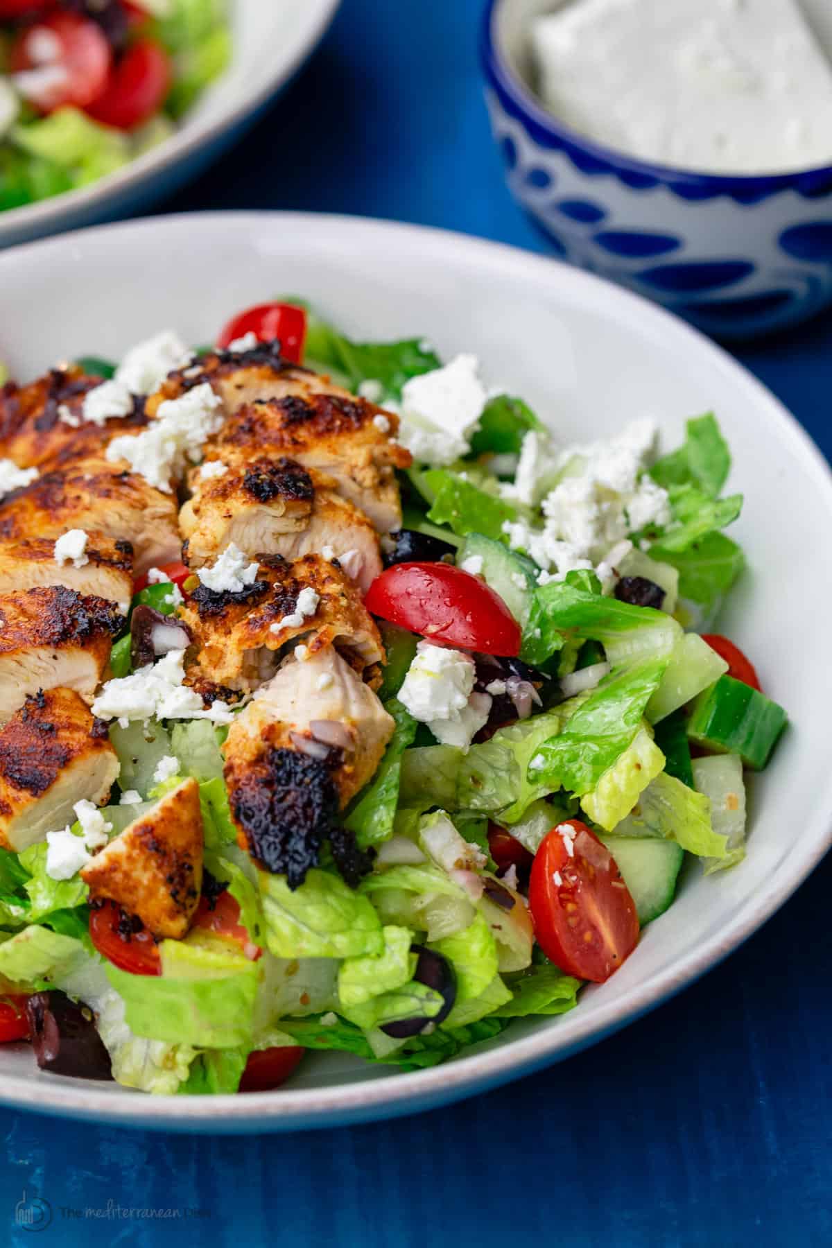 Greek chicken salad served in a white bowl