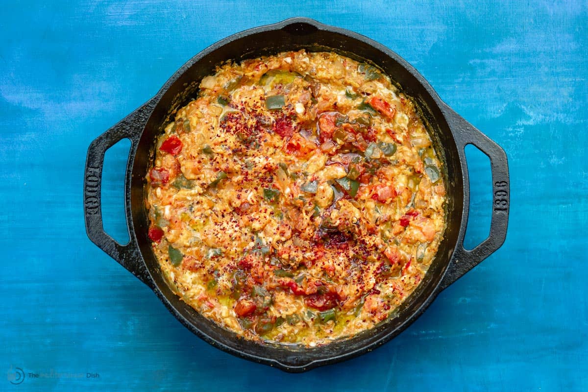 Menemen recipe shown served in cast iron skillet