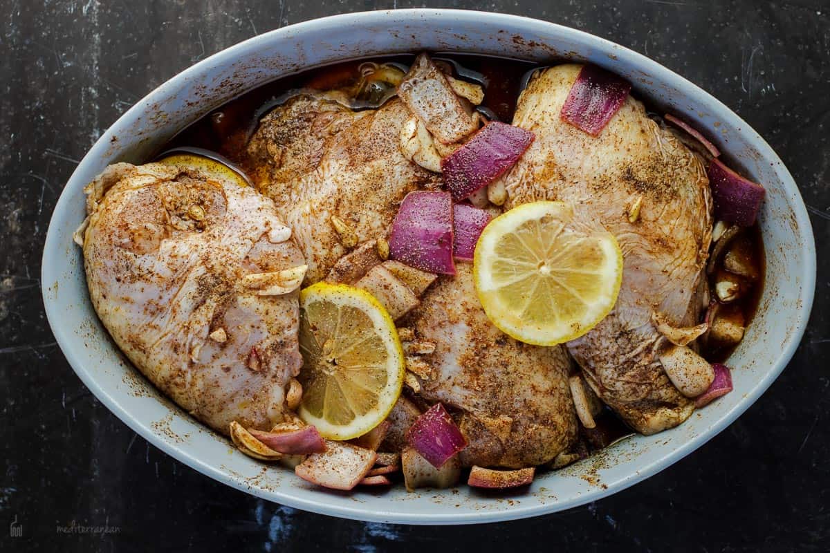 Marinated raw chicken in baking dish