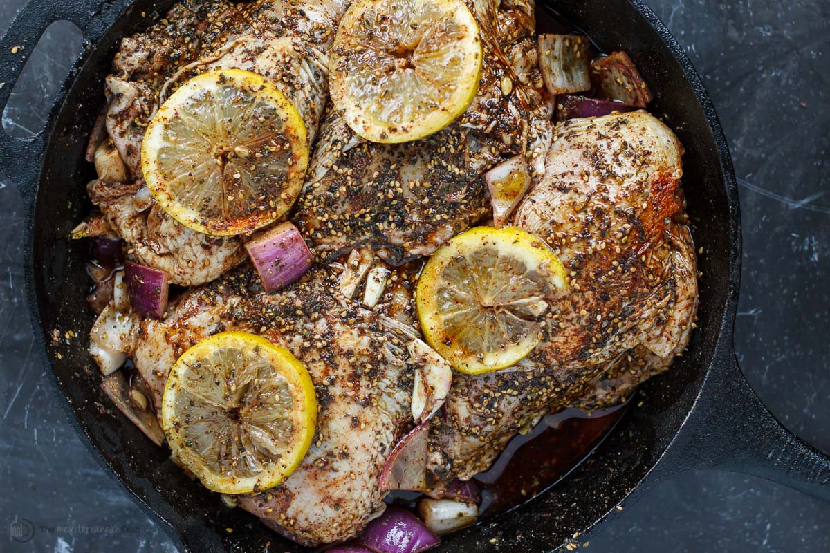 Seasoning chicken breast with za'atar