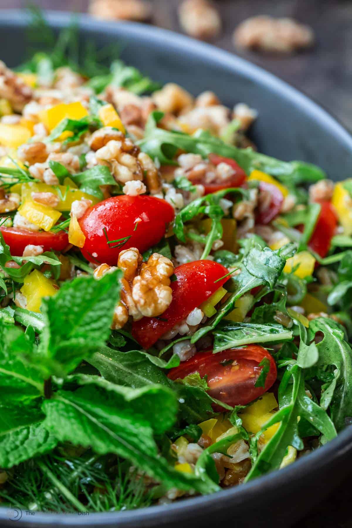 farro salad with arugula and walnuts in a bowl