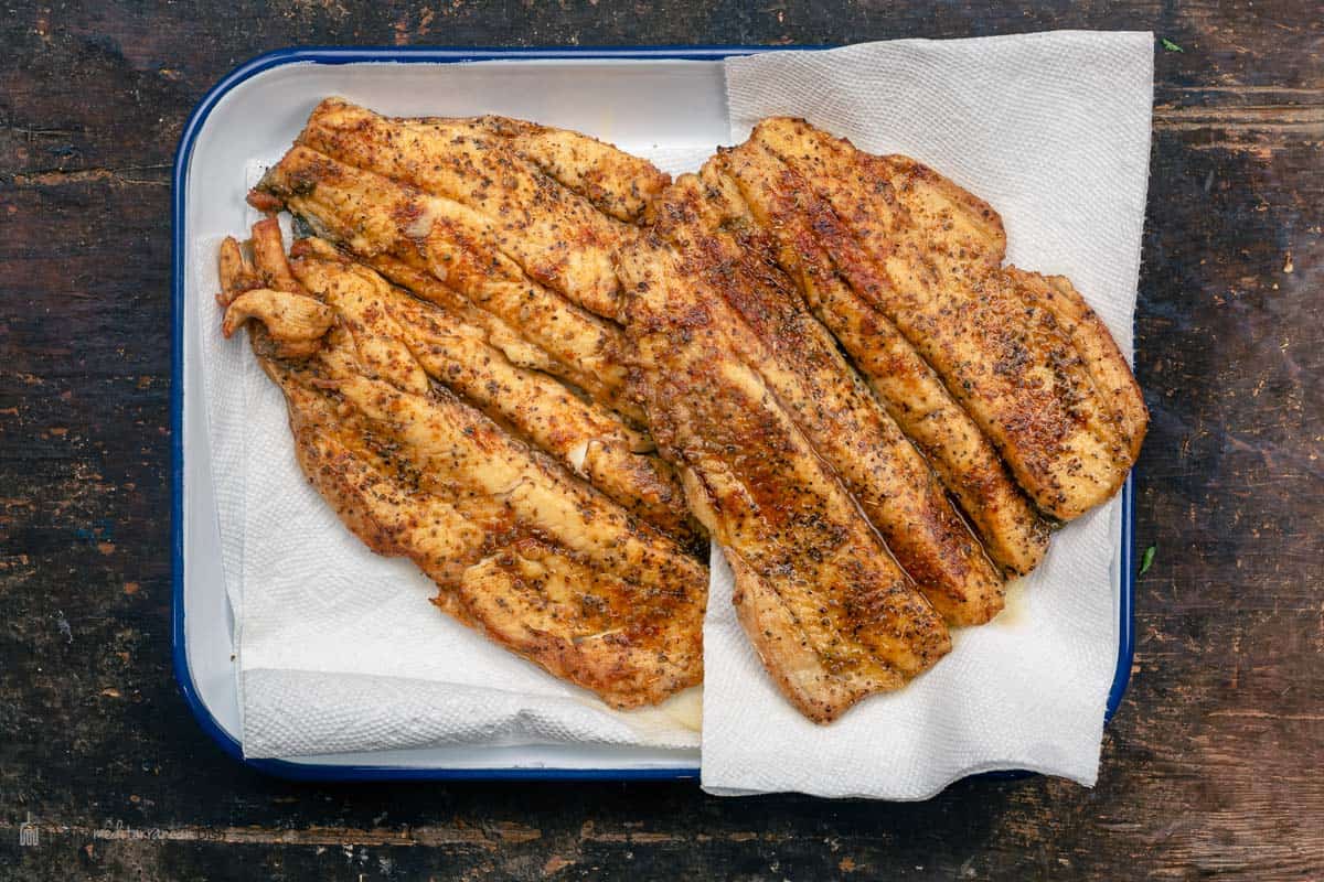 Trout fillets draining on paper towels