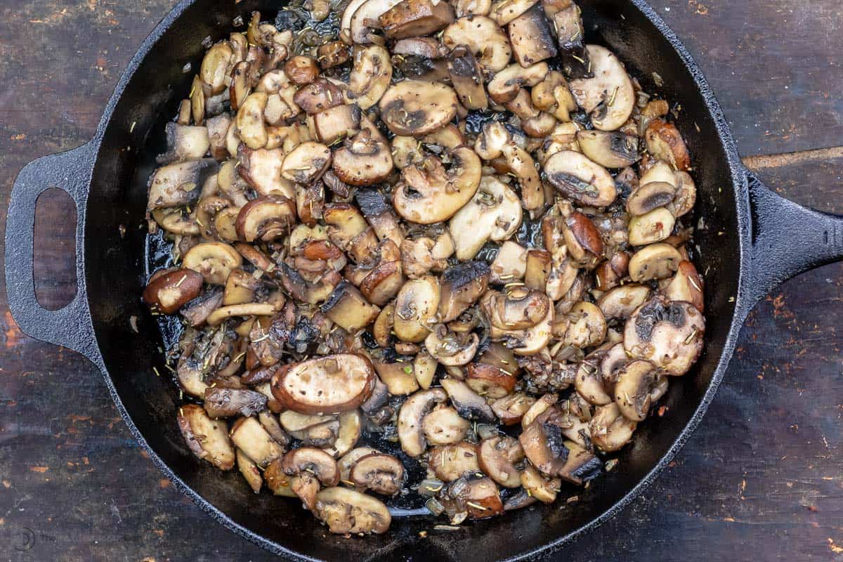 Mushrooms sautÃ©ed in cast iron skillet