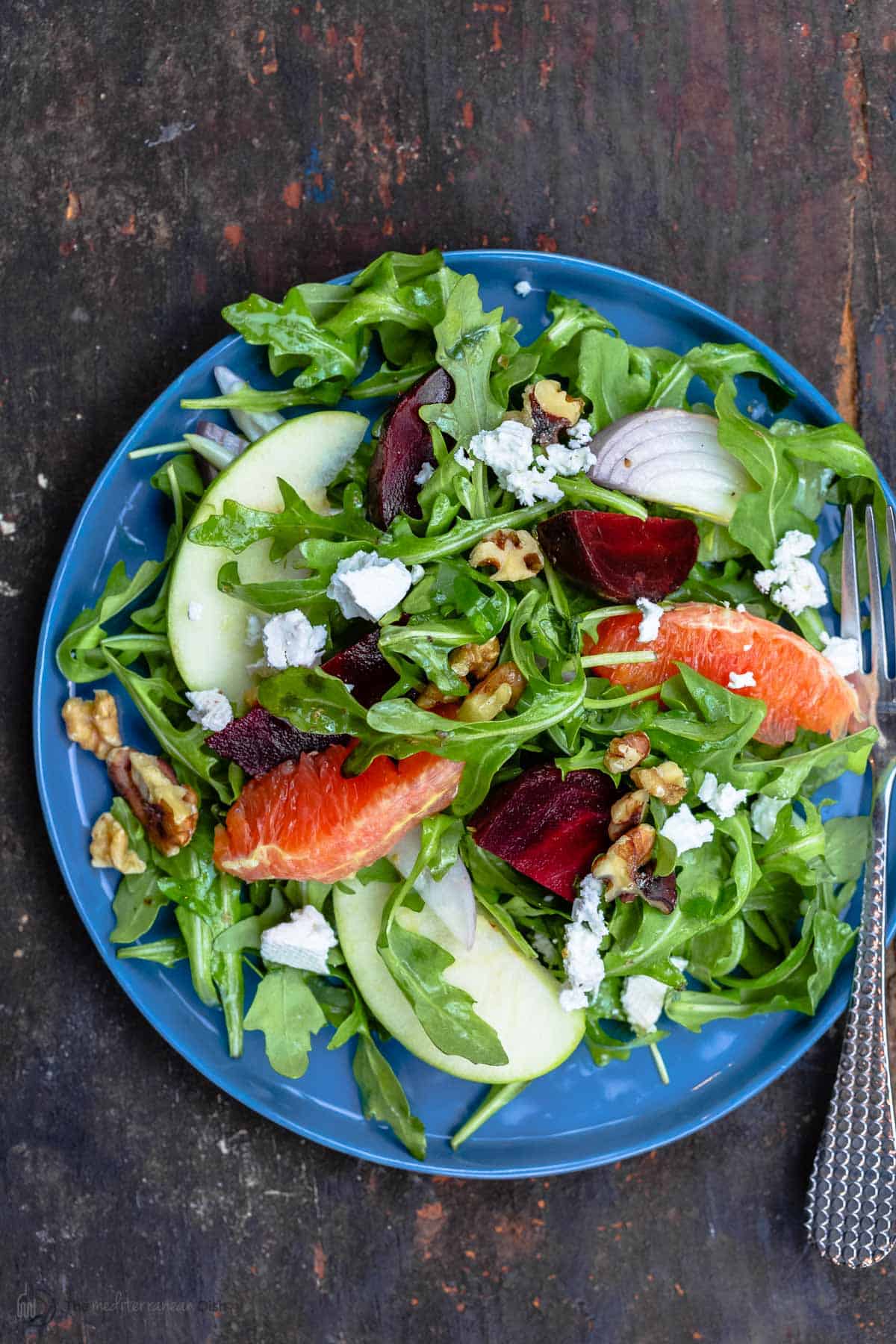 Beet salad served on a blue plate