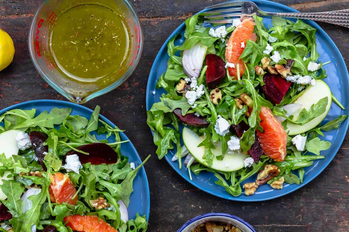 Orange beet salad with arugula served on a plate