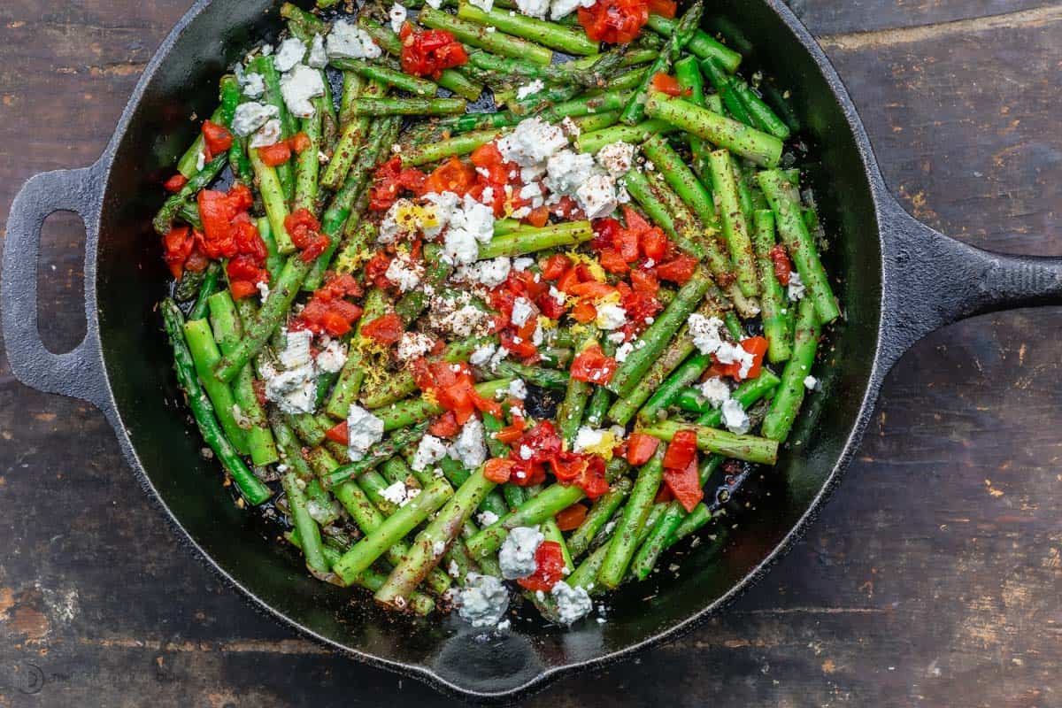 Mediterranean sautéed asparagus with feta lemon and garlic in a skillet